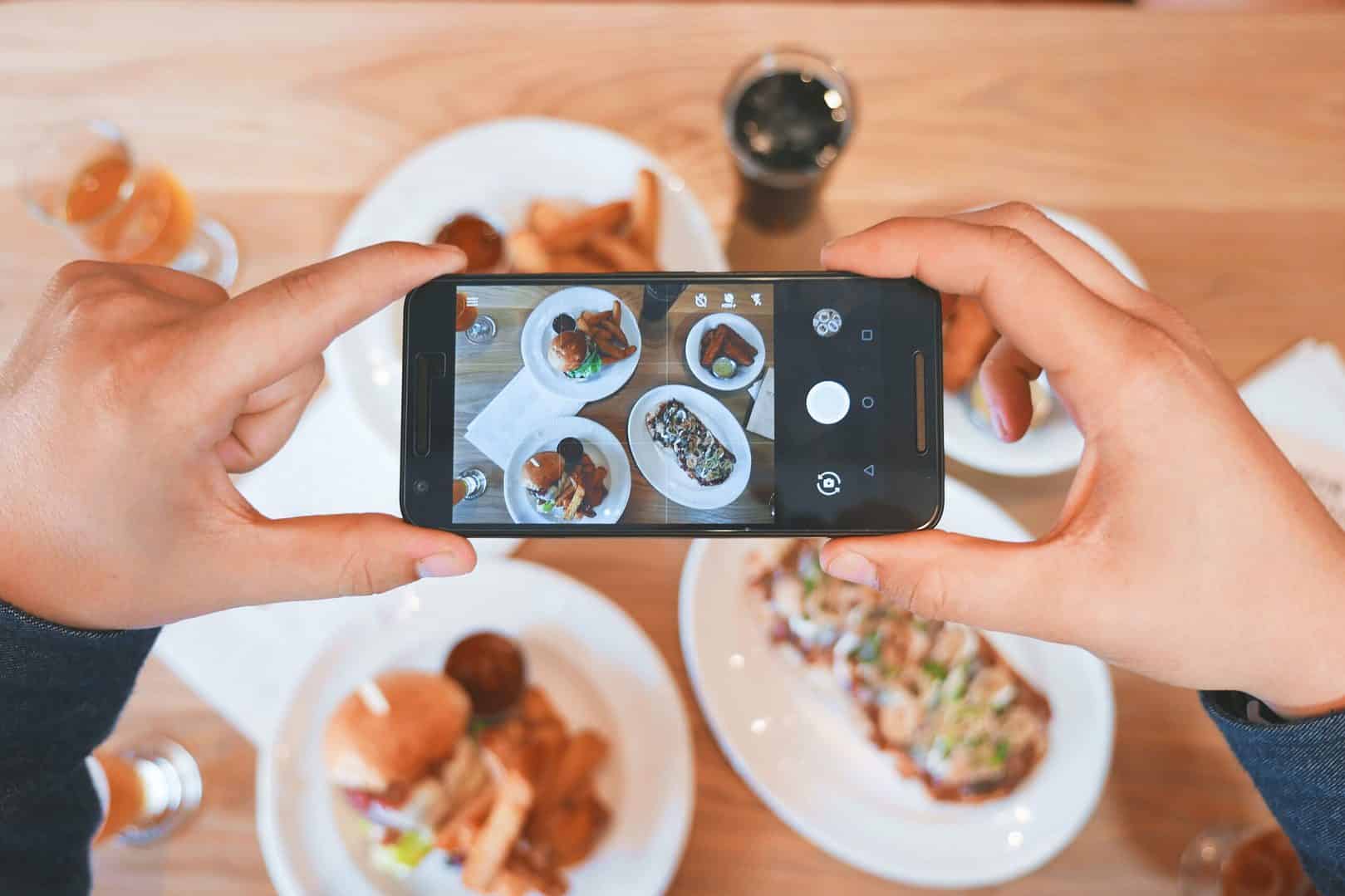 a person taking a picture of their meal with their phone