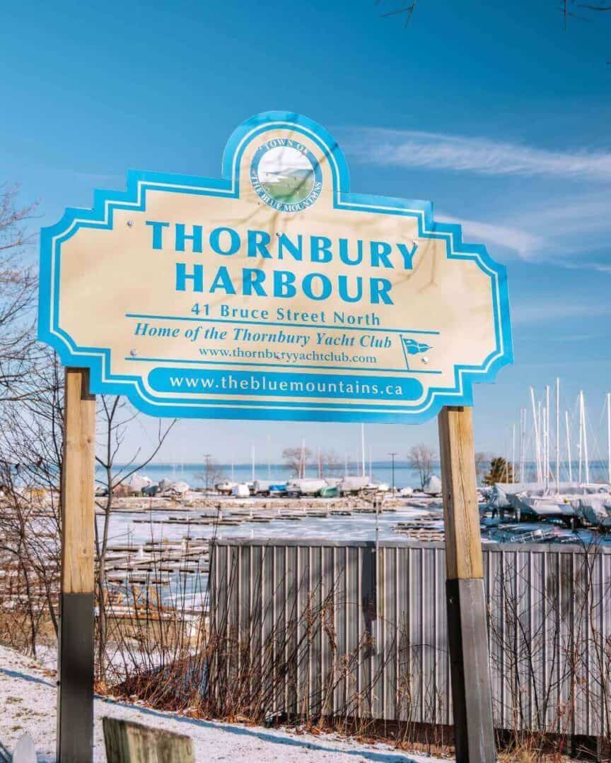 The Thornbury Harbour sign with the harbour in the background in the winter