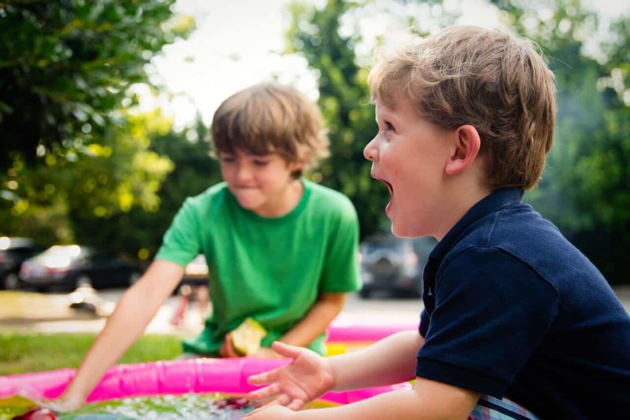 2 boys playing outside having fun